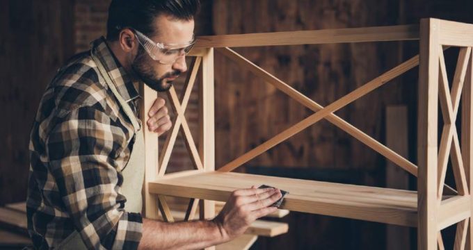 homme qui ponce le bois pour le blanchir