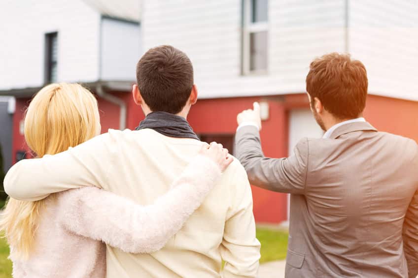 real estate agent shows details to customers
