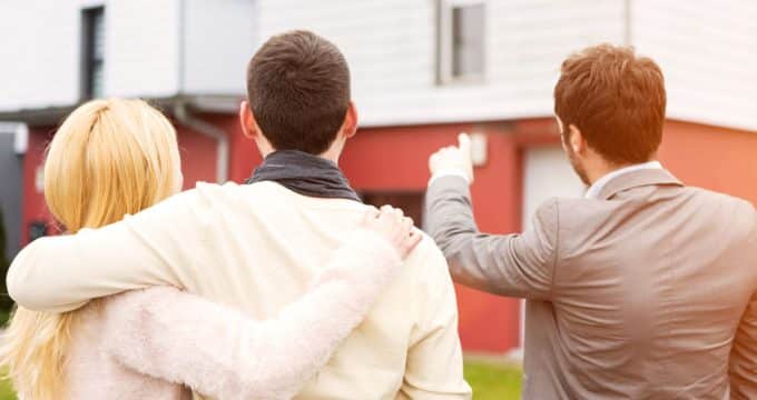 real estate agent shows details to customers