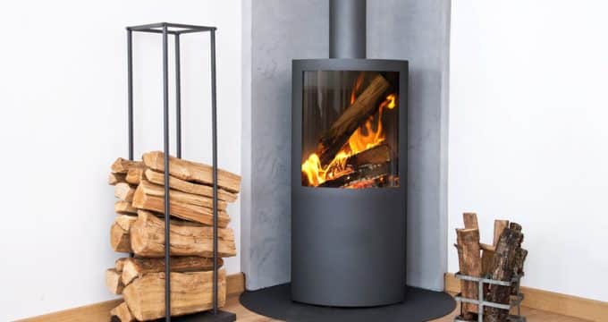 modern burning stove next to a wood logs rack