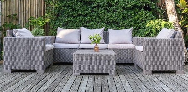 large terrace patio with rattan garden furniture in the garden on wooden floor