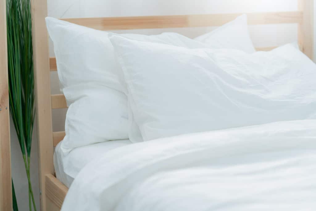 bed maid up with clean white pillows and bed sheets in beauty be