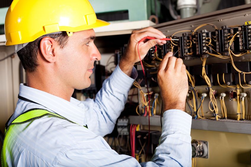 12431512 male electrician testing industrial machine