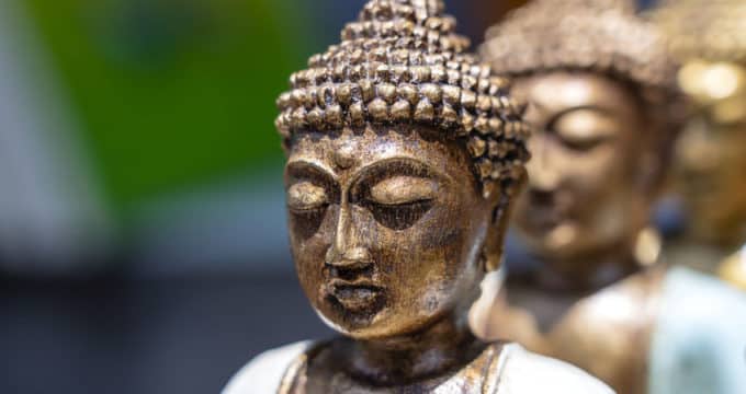 buddha statue figures souvenir on display for sale on street market in bali, indonesia. handicrafts and souvenir shop display, close up