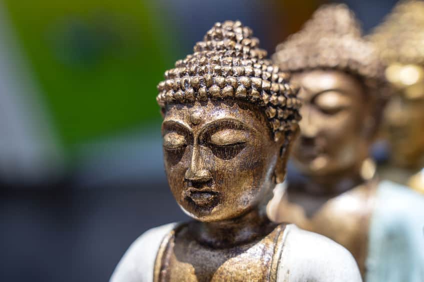 buddha statue figures souvenir on display for sale on street market in bali, indonesia. handicrafts and souvenir shop display, close up